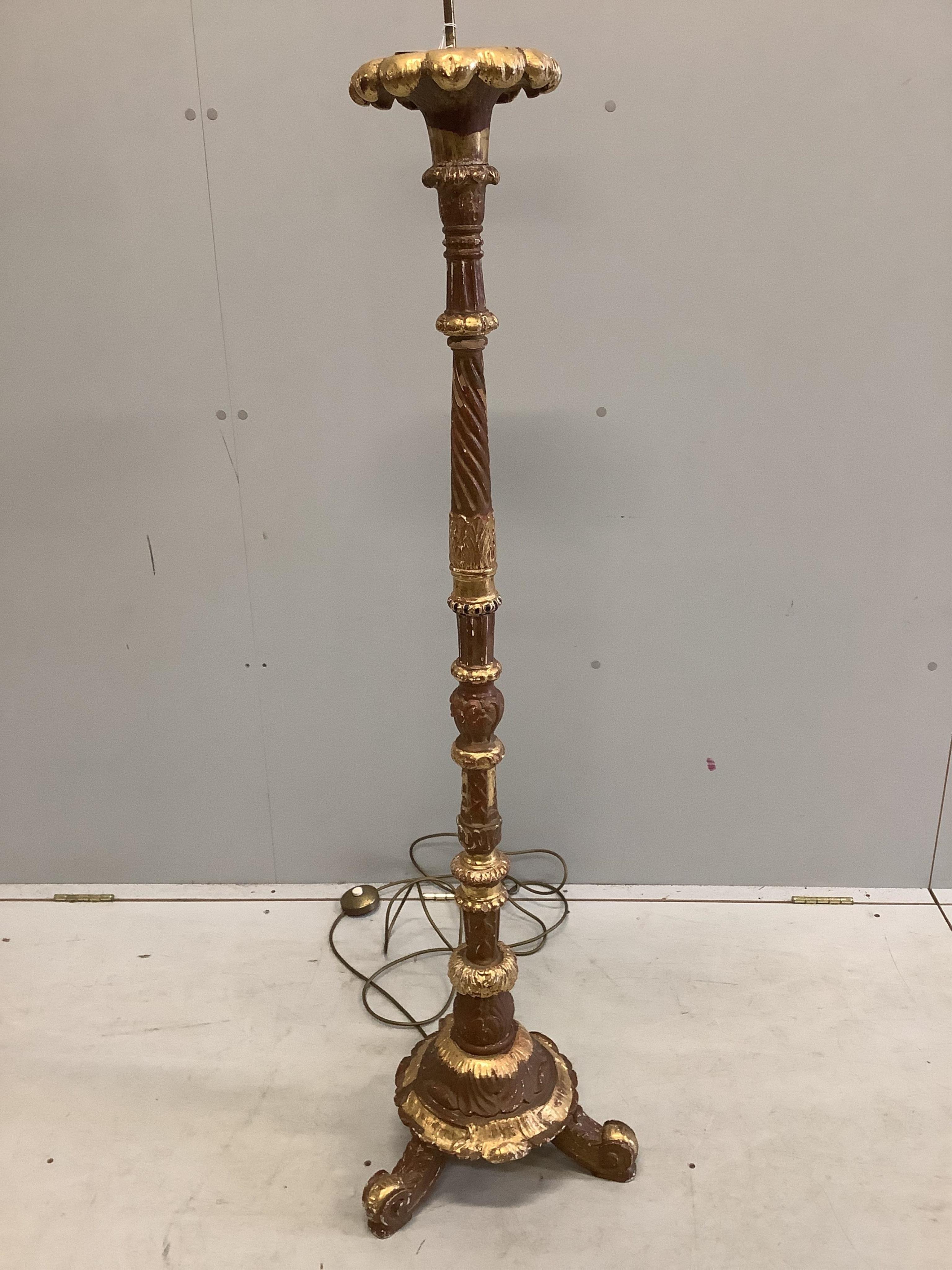 An 18th century style carved giltwood and composition standard lamp, height 175cm. Condition - poor to fair